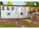 Back exterior showcasing white siding, grey trim, wooden deck, and walkout basement at 398 Baker Nw Cir, Atlanta, GA 30318