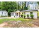Charming single story home with neutral paint, manicured shrubs, and a lovely walkway leading to the front door at 398 Baker Nw Cir, Atlanta, GA 30318
