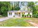 Charming single story home with neutral paint, manicured shrubs, and a lovely walkway leading to the front door at 398 Baker Nw Cir, Atlanta, GA 30318
