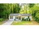 Charming single story home with neutral paint, manicured shrubs, and a lovely walkway leading to the front door at 398 Baker Nw Cir, Atlanta, GA 30318