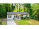 Charming home with manicured bushes, newly updated windows, and a well-maintained lawn at 398 Baker Nw Cir, Atlanta, GA 30318