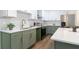 Updated kitchen featuring sleek countertops, stainless appliances, and attractive green and white cabinetry at 398 Baker Nw Cir, Atlanta, GA 30318