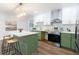 Bright kitchen showcases green and white cabinets, modern appliances, and a central island with countertop seating at 398 Baker Nw Cir, Atlanta, GA 30318