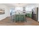 Charming kitchen featuring an island with seating, stainless steel appliances, and stylish green and white cabinetry at 398 Baker Nw Cir, Atlanta, GA 30318