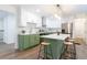 Open kitchen with a large island, modern stainless steel appliances, white upper and green lower cabinets at 398 Baker Nw Cir, Atlanta, GA 30318