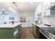 Open concept kitchen with island seating, stainless appliances, and views into the adjacent living area at 398 Baker Nw Cir, Atlanta, GA 30318