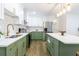 Modern kitchen featuring stylish backsplash, stainless steel appliances, and a kitchen island with storage at 398 Baker Nw Cir, Atlanta, GA 30318