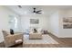 Cozy living room with neutral walls, modern fan, and comfortable seating creating a welcoming space for relaxation at 398 Baker Nw Cir, Atlanta, GA 30318