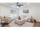 Cozy living room with neutral walls, modern fan, and comfortable seating creating a welcoming space for relaxation at 398 Baker Nw Cir, Atlanta, GA 30318