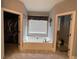 Bathroom with a soaking tub between the walk-in closet and separate toilet area at 605 Red Leaf Way, Canton, GA 30114