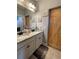 Modern bathroom with double vanity and farmhouse door, complemented by stylish decor and ample space at 605 Red Leaf Way, Canton, GA 30114