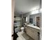 Well-lit bathroom features a shower/tub, toilet, vanity with granite countertop, and tile flooring at 605 Red Leaf Way, Canton, GA 30114