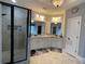 Bright primary bathroom with a large vanity, tile flooring, and walk-in shower at 605 Red Leaf Way, Canton, GA 30114
