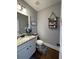 Cozy bathroom featuring granite countertop, decorative shelves, and grey walls at 605 Red Leaf Way, Canton, GA 30114