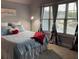 Bright bedroom with large windows, stylish curtains and a cozy bed with a heart-shaped pillow at 605 Red Leaf Way, Canton, GA 30114