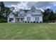 Charming two-story home with white siding, grey shutters, and a well-manicured front lawn at 605 Red Leaf Way, Canton, GA 30114