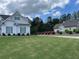 Charming home with well-maintained landscaping, green grass, and vibrant azalea bushes at 605 Red Leaf Way, Canton, GA 30114