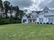 Charming two-story home with white siding, grey shutters, and a well-manicured front lawn at 605 Red Leaf Way, Canton, GA 30114