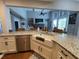 Kitchen island with granite countertop, undermount sink and view into Gathering room at 605 Red Leaf Way, Canton, GA 30114