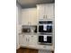 Bright kitchen featuring stainless double ovens, white cabinets and granite counters at 605 Red Leaf Way, Canton, GA 30114