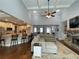 Open-concept living room featuring a vaulted ceiling, fireplace, and seamless transition into the kitchen at 605 Red Leaf Way, Canton, GA 30114