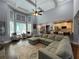 Expansive living room featuring tray ceilings, large windows, and comfortable seating at 605 Red Leaf Way, Canton, GA 30114