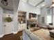 Spacious living room featuring a stone fireplace, built-in shelves, and tray ceilings at 605 Red Leaf Way, Canton, GA 30114