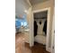 View of the mudroom with storage cabinets and hardwood floors adjacent to the kitchen with modern appliances at 605 Red Leaf Way, Canton, GA 30114