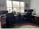 Spacious home office featuring large windows, hardwood floors, and dual workstations, ideal for productivity at 605 Red Leaf Way, Canton, GA 30114