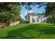 A spacious green backyard featuring a patio, swing and basketball hoop at 1093 Forest View Sw Ln, Lilburn, GA 30047