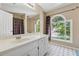 Bright bathroom with a large window, neutral color scheme, and lots of natural light at 1093 Forest View Sw Ln, Lilburn, GA 30047