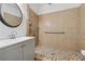 Modern bathroom features a stand up shower with pebble floor, plus a sink with black framed mirror at 1093 Forest View Sw Ln, Lilburn, GA 30047