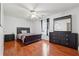 This cozy bedroom features a large window, wood floors, and dark colored furniture at 1093 Forest View Sw Ln, Lilburn, GA 30047
