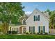 Charming two-story home featuring stone accents, a covered porch, and lush green landscaping at 1093 Forest View Sw Ln, Lilburn, GA 30047