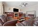 Spacious living room showcases a fireplace, ceiling fan, hardwood floors, and a cozy atmosphere at 1093 Forest View Sw Ln, Lilburn, GA 30047