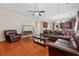 Relaxing living room featuring hardwood floors, cozy furniture, and seamless kitchen access at 1093 Forest View Sw Ln, Lilburn, GA 30047