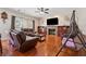 Spacious living room showcases a fireplace, ceiling fan, hardwood floors, and a cozy atmosphere at 1093 Forest View Sw Ln, Lilburn, GA 30047