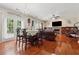 Open concept living area with hardwood floors, connecting dining and living spaces at 1093 Forest View Sw Ln, Lilburn, GA 30047