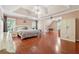 Spacious main bedroom boasts hardwood floors, tray ceiling, and neutral colors at 1093 Forest View Sw Ln, Lilburn, GA 30047