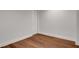 Unfinished basement space features hardwood floors, neutral walls, and an access door at 118 Via Roma, Woodstock, GA 30188