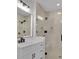 Modern bathroom features a frameless glass shower, white vanity, and matte black hardware at 118 Via Roma, Woodstock, GA 30188