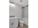 Bright bathroom with white subway tile in shower, white vanity, toilet, and modern black fixtures at 118 Via Roma, Woodstock, GA 30188