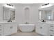 Modern bathroom features dual vanities, soaking tub, and tile flooring at 118 Via Roma, Woodstock, GA 30188