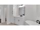 Bright bathroom boasts a modern vanity with sleek black fixtures and a stylish soaking tub at 118 Via Roma, Woodstock, GA 30188