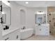 Elegant bathroom features dual vanities, soaking tub, and frameless glass shower at 118 Via Roma, Woodstock, GA 30188