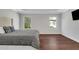 Bright bedroom features hardwood floors, two windows, and neutral decor at 118 Via Roma, Woodstock, GA 30188