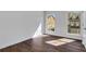 Bright bedroom with hardwood floors and two windows offering views of the exterior at 118 Via Roma, Woodstock, GA 30188
