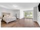 Spacious bedroom with wood floors, large window providing lots of natural light, and a decorative bed frame at 118 Via Roma, Woodstock, GA 30188