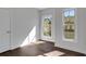 Sunlit bedroom with hardwood flooring, windows, and neutral wall color at 118 Via Roma, Woodstock, GA 30188