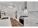 Modern kitchen featuring white cabinets, stainless steel appliances, and sleek countertops at 118 Via Roma, Woodstock, GA 30188